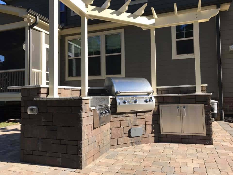 Outdoor kitchen paver with pergola on top
