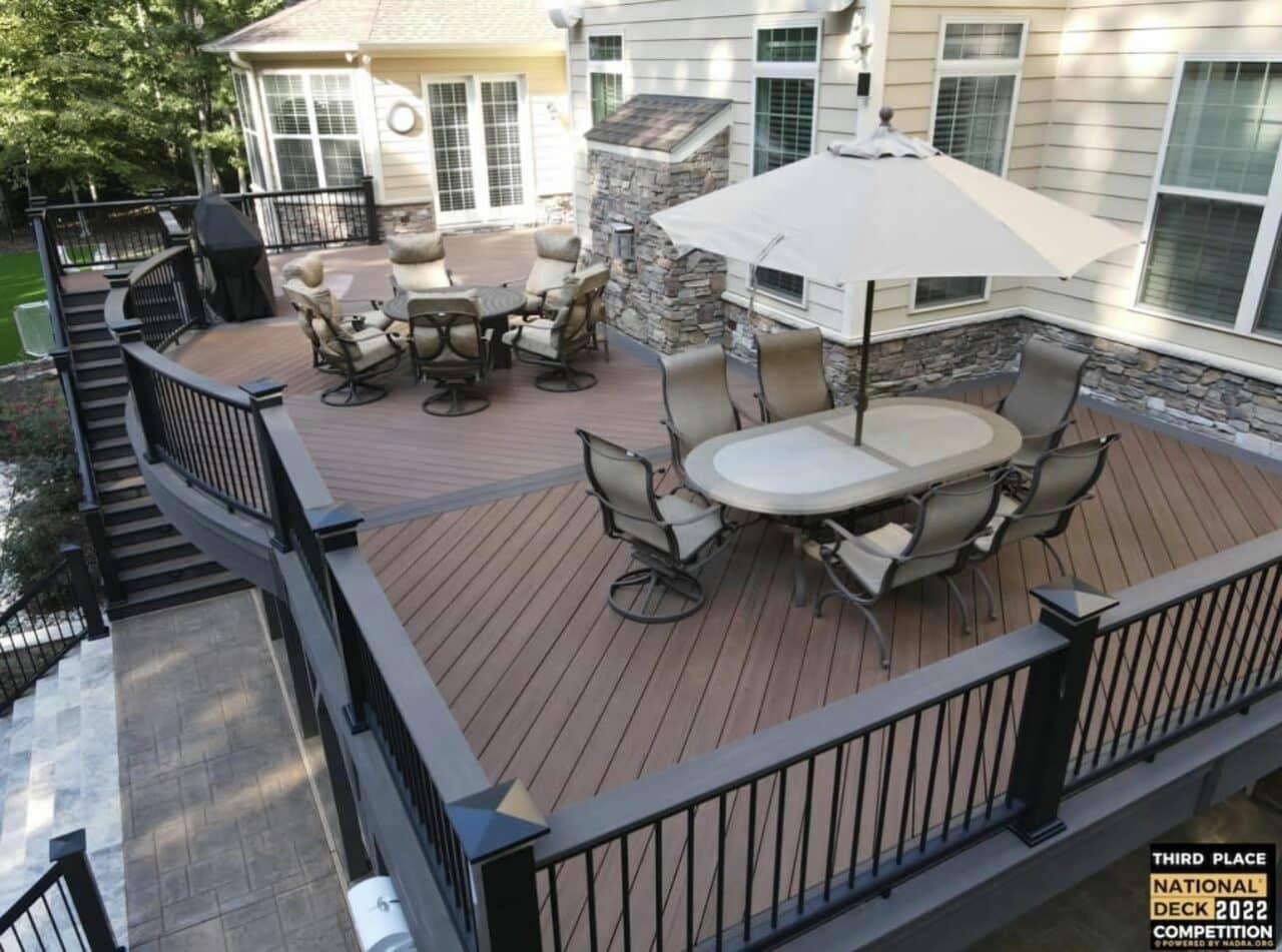 Photo of a composite deck with outdoor furniture and deck railing.