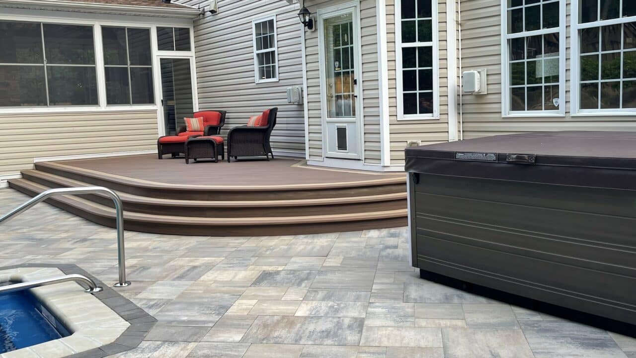 Photo of a paver patio with a curved deck.