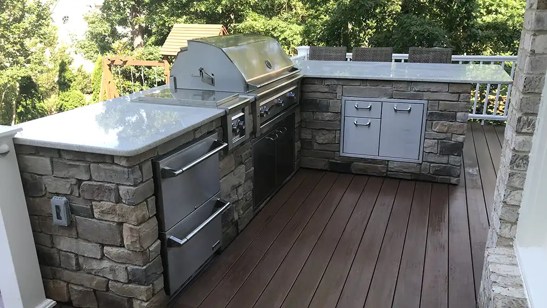 Photo of L-shaped outdoor kitchen.