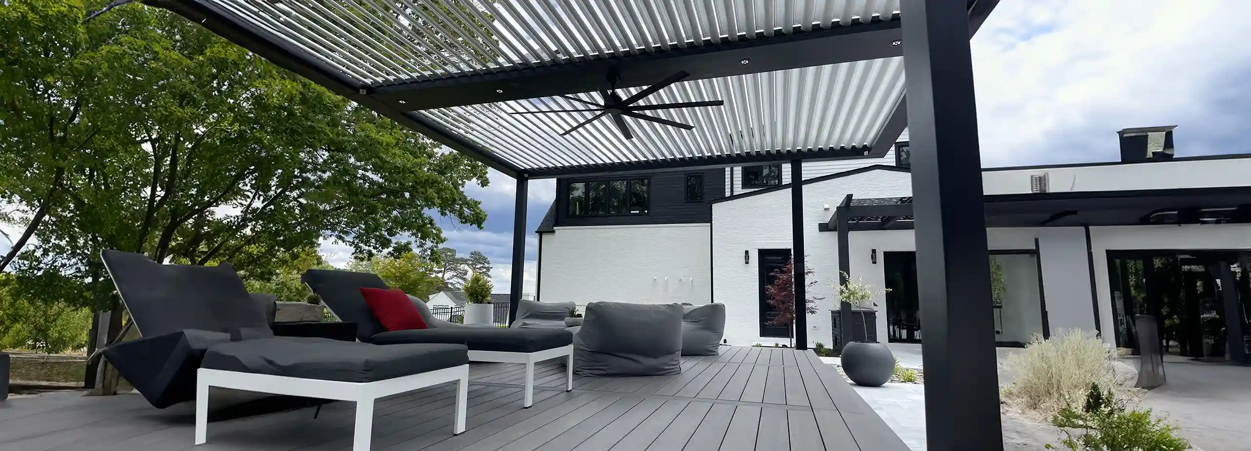 photo of a StruXure Pergola X, a smart pergola, with ceiling fan and outdoor furniture