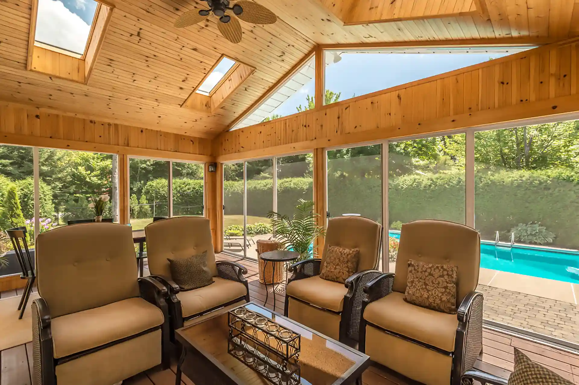 Photo of a covered back porch with porch skylights, ceiling fan, and outdoor furniture