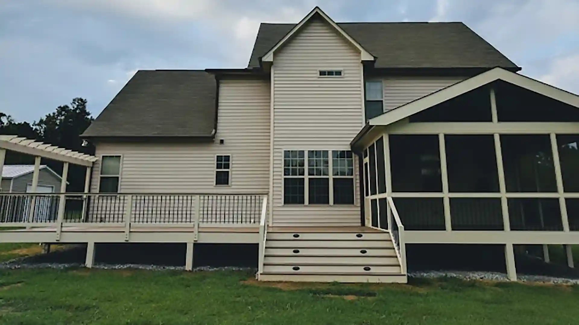 photo of a deck with screened-in area and pergola to support story about when is the best time to a deck