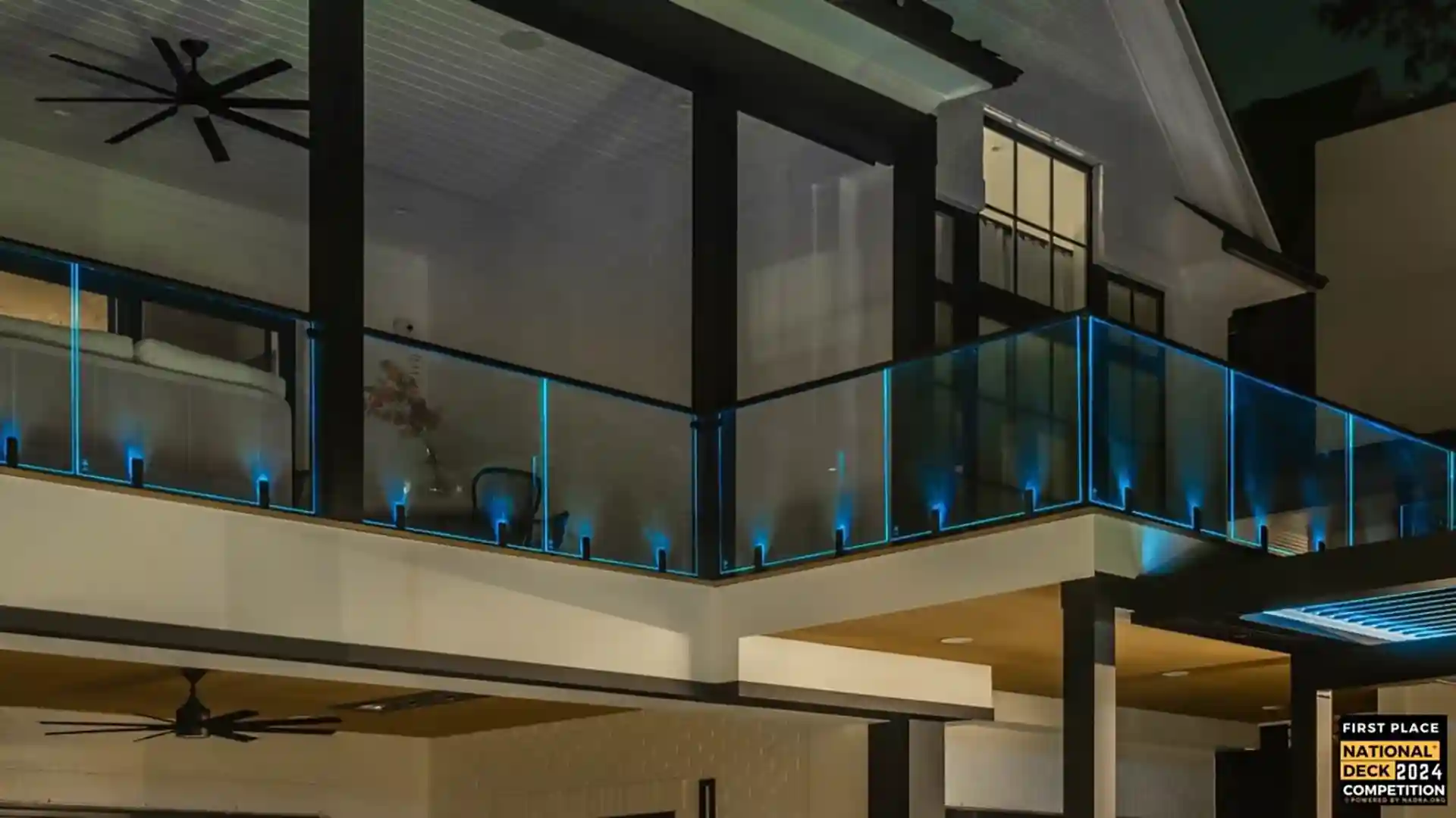 photo of a raised deck with glas panels, stylish deck lighting, a covered deck area with ceiling fan