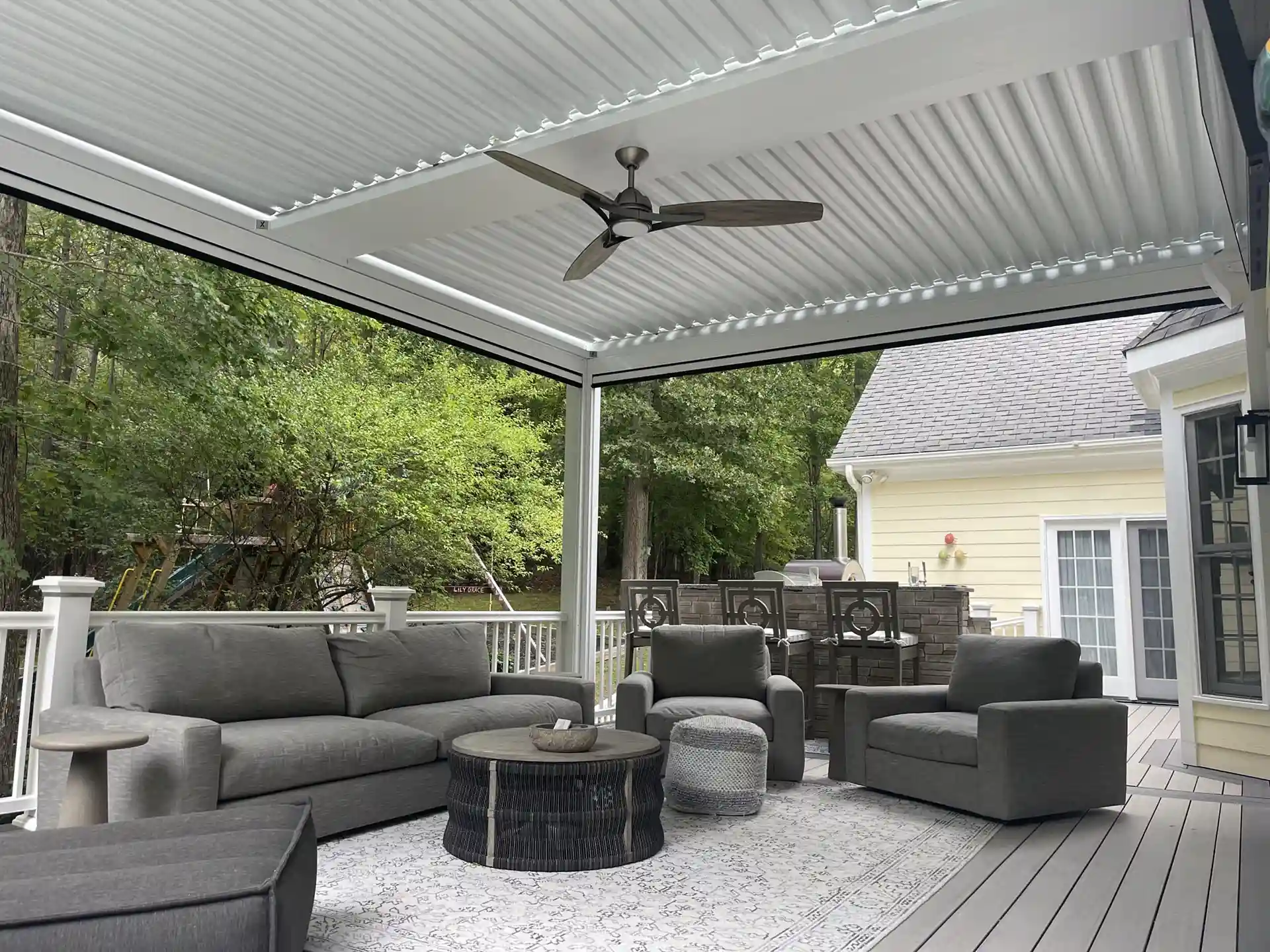Photo of a deck with pergola and ceiling fan to help keep the deck area cooler.