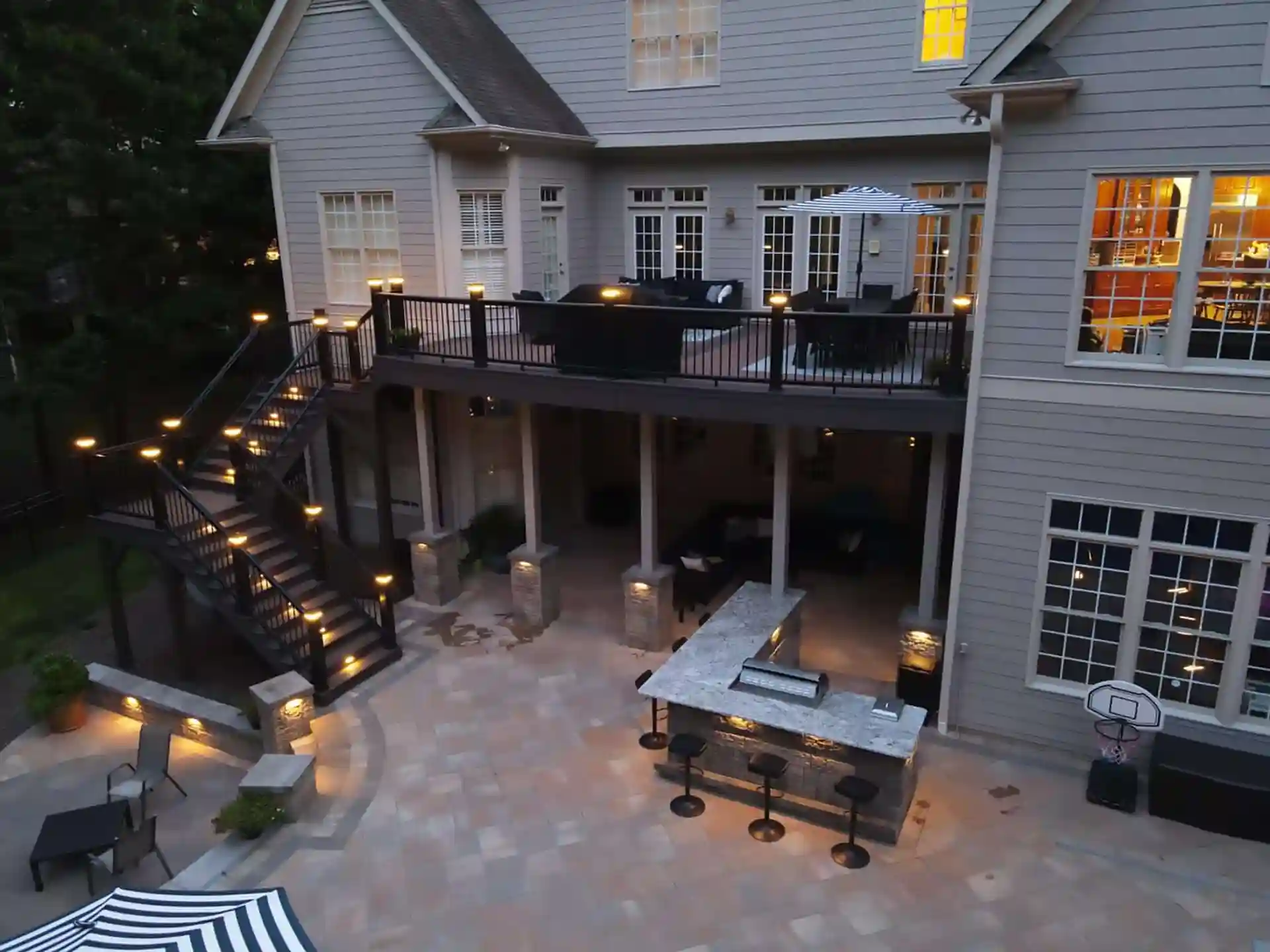 PHoto of an elevated deck with post cap lighting and in-step deck lighting