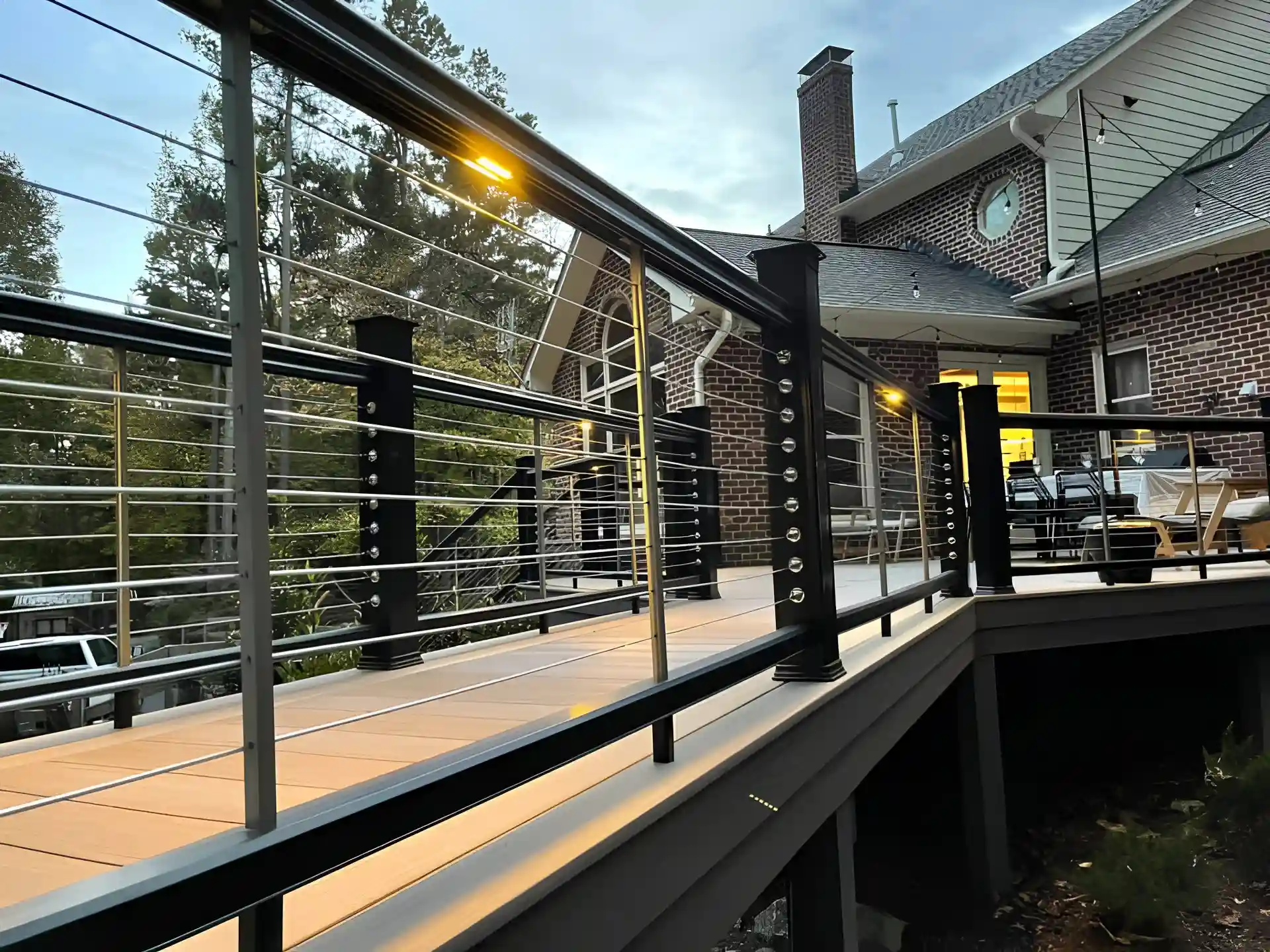 Photo of a composite deck and walkway with cable railing.